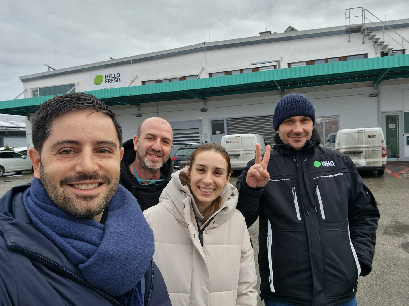 The RiDERgy team in front of the HelloFresh depot with its delivery vans